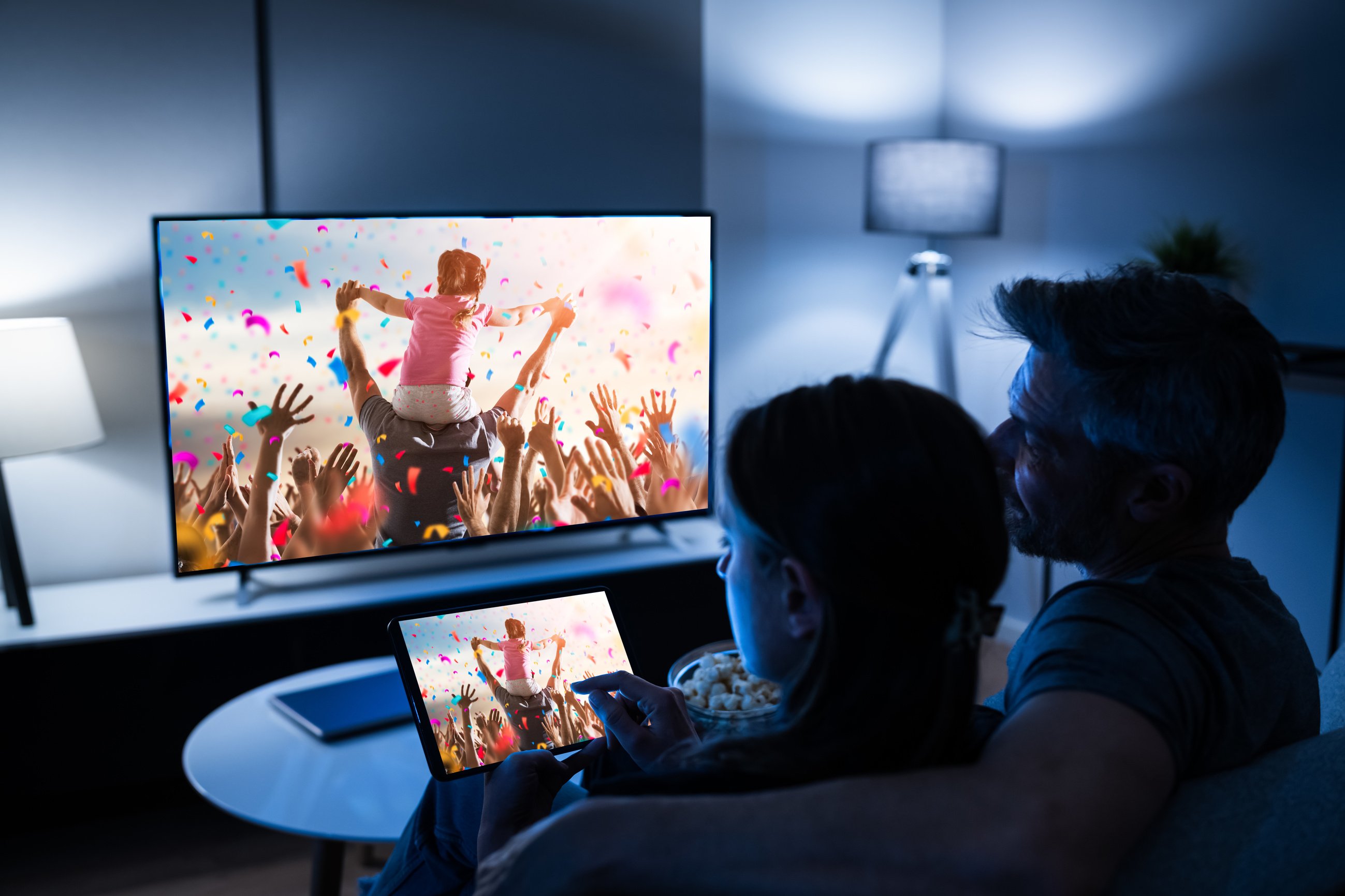 Family Watching TV Through Tablet Television