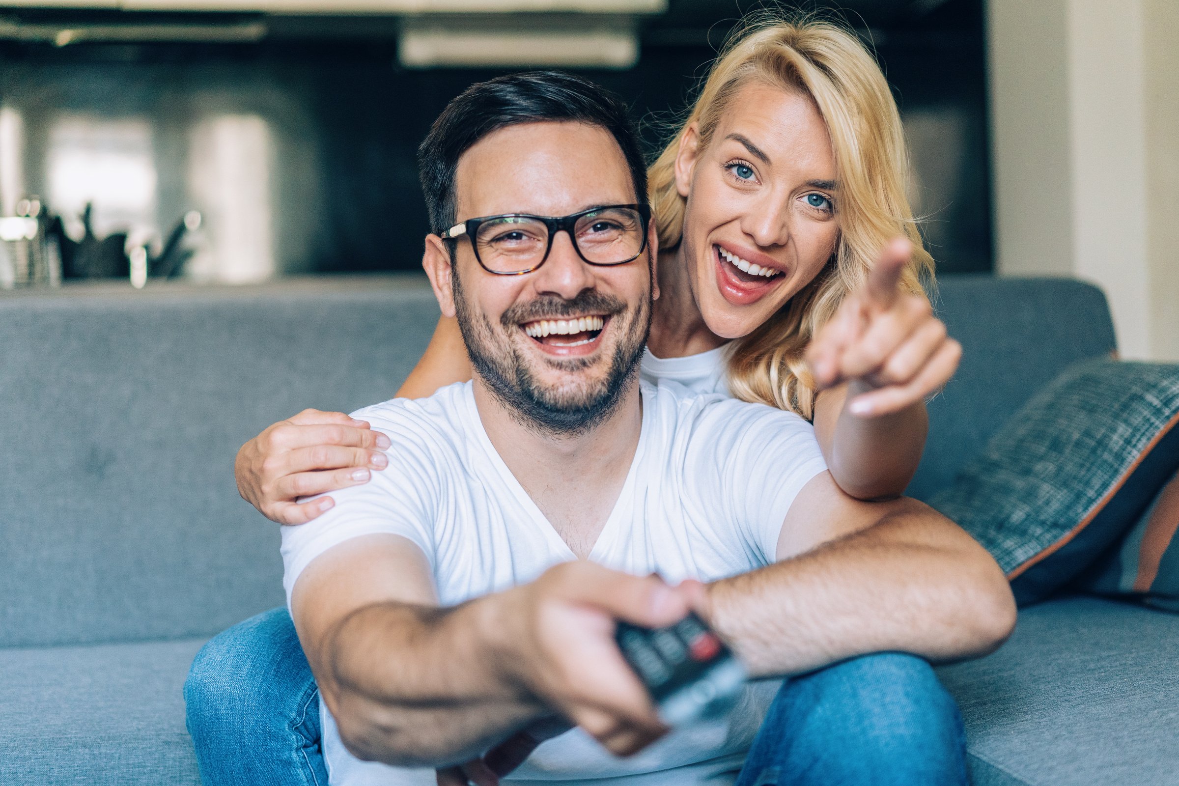 Happy couple watching tv